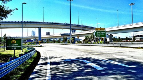 Bridges over road in city against sky