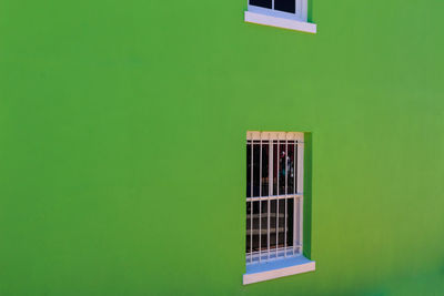 Close-up of window on green wall