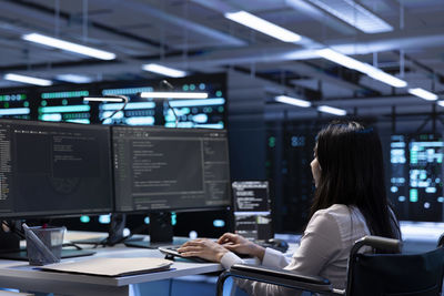 Young woman using laptop in cafe