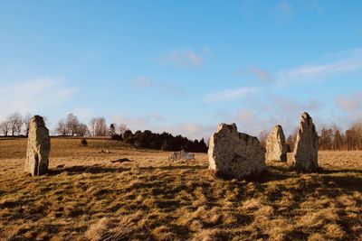 Hay bales on field against sky