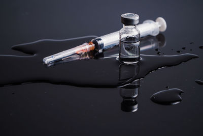 Close up vaccines and syringe on the table