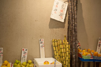 Fruits for sale by wall at market stall