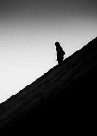 Low angle view of silhouette person against mountain