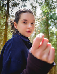 Portrait of woman holding plant