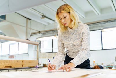 Young woman working on table