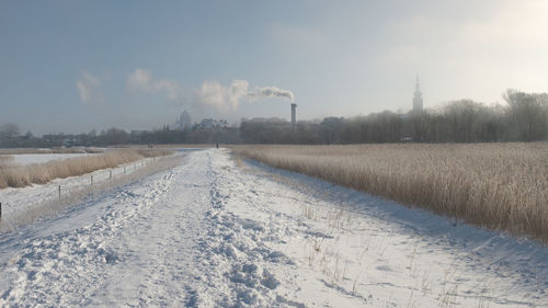 Scenic view of field against sky during winter