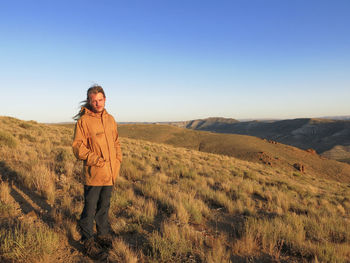 Man standing on field against clear sky