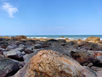 Rocks on beach against sky