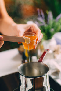 Woman making homemade soap with honey