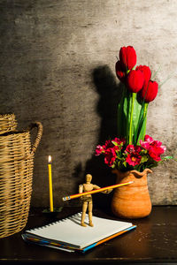 Still life photography with notebook on a wooden desk. light a candle.