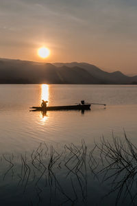 Scenic view of lake against sky during sunset