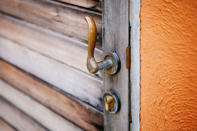 Close-up vintage style door handle of brass on old wooden door