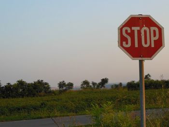 Road sign against clear sky