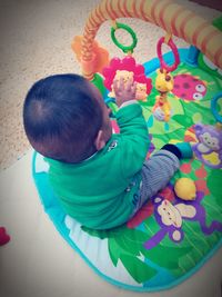 High angle view of baby boy playing with toy