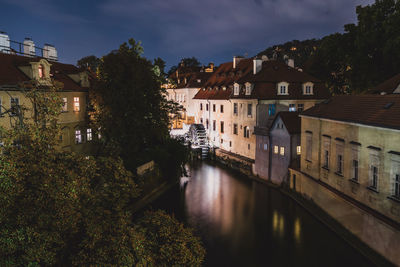 Canal amidst buildings against sky