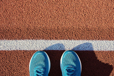 Blue running sneakers at stadium track