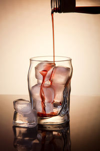 Close-up of drink pouring in glass