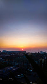 High angle view of buildings in city during sunset