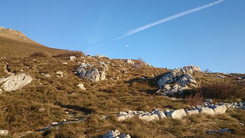 Scenic view of mountains against blue sky