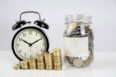 Close-up of coins on table against white background