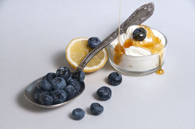 High angle view of fruit in plate against white background