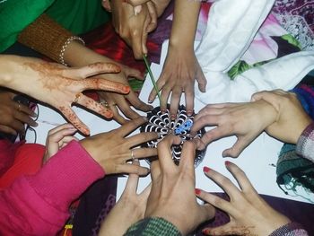 Low section of people sitting on tiled floor
