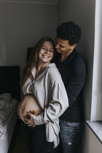 Pregnant woman with partner standing together