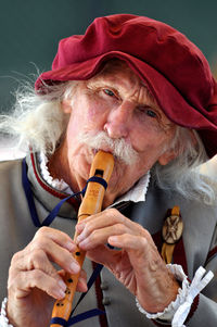 Close-up portrait of man holding camera