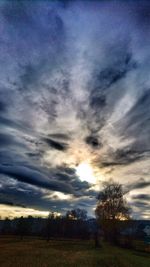 Scenic view of dramatic sky over field