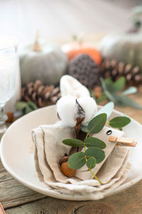 Autumn table decor. table setting with eucalyptus branches, pumpkins, cones and nuts,. top view.