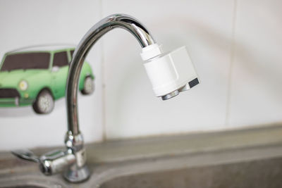 Close-up of faucet in bathroom