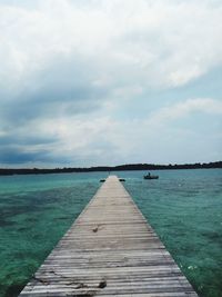 Pier over sea against sky