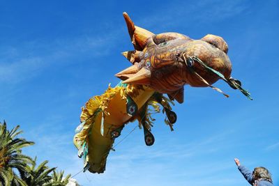 Low angle view of two birds against clear blue sky