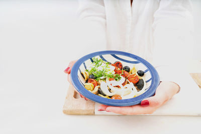 Midsection of woman holding bowl of salad