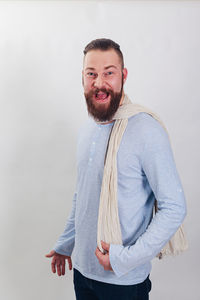 Portrait of happy man standing against white background