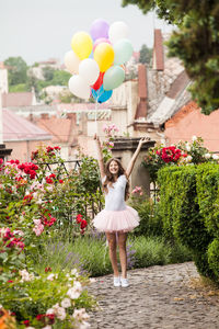 Rear view of woman holding colorful balloons