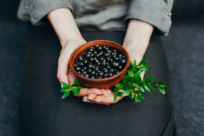 Midsection of woman holding fruit