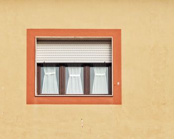 Low angle view of window on wall of building