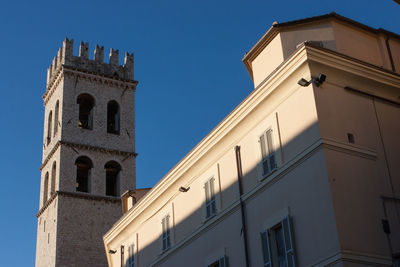 Low angle view of bell tower against blue sky