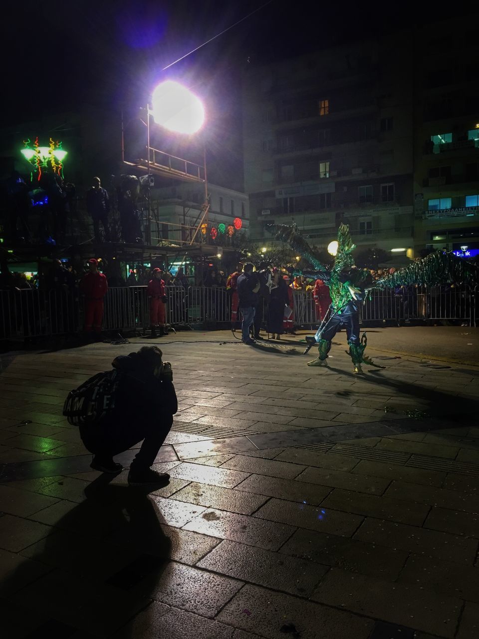 MEN IN ILLUMINATED CITY