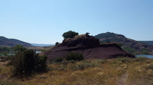 Scenic view of land against clear blue sky