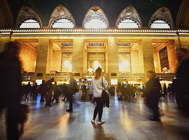 indoors, lifestyles, men, person, architecture, large group of people, leisure activity, full length, arch, built structure, walking, standing, flooring, casual clothing, railroad station, corridor, illuminated, architectural column, travel