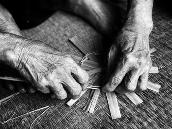 Midsection of man working on table