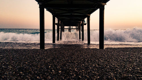 Scenic view of beach against clear sky during sunset