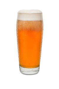 Close-up of beer glass against white background