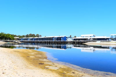 View of built structures against clear blue sky