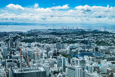 High angle view of modern buildings in city against sky