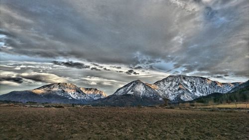 Scenic view of mountains against cloudy sky