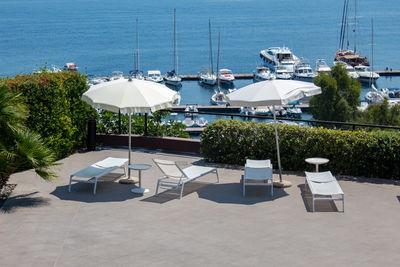 Lounge chairs by swimming pool