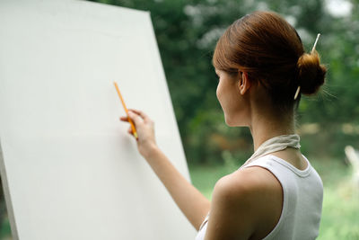 Side view of woman holding hands